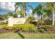 Elegant community sign surrounded by lush landscaping and mature palm trees, welcoming residents and visitors at 3459 Lakewood Blvd, North Port, FL 34287