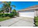 Charming home featuring a two-car garage, manicured landscaping, and a well-maintained lawn at 3459 Lakewood Blvd, North Port, FL 34287
