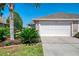Charming home featuring a two-car garage, manicured landscaping, and a well-maintained lawn at 3459 Lakewood Blvd, North Port, FL 34287