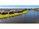 Beautiful waterfront homes featuring screened lanais and lush green lawns leading to a serene lake at 3459 Lakewood Blvd, North Port, FL 34287