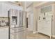 Bright kitchen with stainless steel refrigerator and white cabinets, perfect for cooking and entertaining at 3459 Lakewood Blvd, North Port, FL 34287