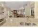 Cozy dining table leading to a living space with comfortable seating and abundant natural light at 3459 Lakewood Blvd, North Port, FL 34287