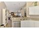 Stylish kitchen area with granite countertops that opens into a comfortable living space at 3459 Lakewood Blvd, North Port, FL 34287