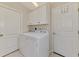 Convenient laundry area with white washer and dryer units, plus cabinet storage at 3459 Lakewood Blvd, North Port, FL 34287