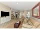 Inviting living room with a comfortable leather sofa and entertainment center, perfect for relaxing and entertaining at 3459 Lakewood Blvd, North Port, FL 34287