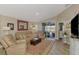 Comfortable living room with a leather sofa set, a cozy rug, and seamless access to the outdoor patio at 3459 Lakewood Blvd, North Port, FL 34287