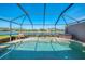 Relaxing screened pool with a serene waterfront view overlooking the tranquil lake at 3459 Lakewood Blvd, North Port, FL 34287