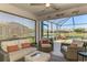 Inviting sunroom with comfortable seating and a view of the pool and lake at 3459 Lakewood Blvd, North Port, FL 34287
