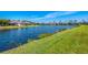 Lush green lawn meets the tranquil waterfront, creating a peaceful setting for waterfront homes at 3459 Lakewood Blvd, North Port, FL 34287