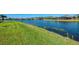 Lush green lawn leading down to the peaceful waterfront, a perfect backdrop for any home at 3459 Lakewood Blvd, North Port, FL 34287