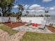 Charming backyard area featuring lounge chairs, playset, and fenced yard, perfect for outdoor activities at 4070 Kincord Ln, North Port, FL 34287
