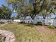 Spacious backyard featuring a white privacy fence, play area, and well-manicured lawn with mature shade trees at 4070 Kincord Ln, North Port, FL 34287
