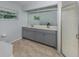 Bright bathroom with double vanity, a large mirror, and tiled floors at 4070 Kincord Ln, North Port, FL 34287