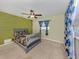 bedroom with a green accent wall and light yellow walls plus carpeted flooring at 4070 Kincord Ln, North Port, FL 34287