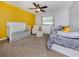 Comfortable bedroom with grey and yellow accents, and carpeted flooring at 4070 Kincord Ln, North Port, FL 34287