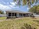Well-maintained home exterior featuring sunroom addition and a lush backyard with a stone paver walkway at 4070 Kincord Ln, North Port, FL 34287
