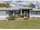 Well maintained front yard with grass, manicured landscaping, and mulch around the house at 4070 Kincord Ln, North Port, FL 34287