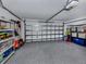Spacious garage with epoxy flooring and ample storage shelves on either side, and an automatic garage door at 4070 Kincord Ln, North Port, FL 34287