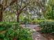 Secluded garden swing nestled among lush greenery and mature trees at 4070 Kincord Ln, North Port, FL 34287