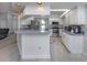 Open kitchen featuring stainless steel appliances, ample counter space, and a stylish breakfast bar at 4070 Kincord Ln, North Port, FL 34287