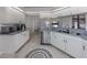 Bright kitchen with stainless steel appliances, light wood flooring, and plentiful counter space at 4070 Kincord Ln, North Port, FL 34287