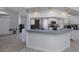 Kitchen bar with bright white cabinets and modern appliances, and view into the kitchen at 4070 Kincord Ln, North Port, FL 34287