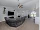 Spacious living room with modern furniture, neutral colors, and a large TV at 4070 Kincord Ln, North Port, FL 34287
