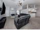 Open-concept living room features plush carpeting and a view of the entryway and kitchen at 4070 Kincord Ln, North Port, FL 34287