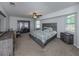 Cozy main bedroom with a ceiling fan, natural light, and neutral decor at 4070 Kincord Ln, North Port, FL 34287