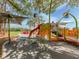 A playground under the trees features a red slide, green climbing structure, and orange butterfly decorations at 4070 Kincord Ln, North Port, FL 34287