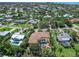 Aerial view of the property featuring the pool, patio, balcony, and lush landscaping at 416 Baycrest Dr, Venice, FL 34285