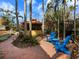 Backyard featuring lush tropical landscaping, a gazebo, and blue Adirondack chairs for relaxed outdoor living at 416 Baycrest Dr, Venice, FL 34285