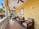 Spacious outdoor balcony featuring stucco walls, comfortable seating, and ceiling fans for outdoor relaxation at 416 Baycrest Dr, Venice, FL 34285