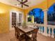 Outdoor dining area featuring a wooden table, stucco walls, and classic columns, creating a cozy atmosphere at 416 Baycrest Dr, Venice, FL 34285