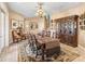 Traditional dining room with decorative rug, chandelier, and antique hutch at 416 Baycrest Dr, Venice, FL 34285