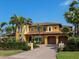 Mediterranean style home with lush landscaping, brick driveway and three car garage at 416 Baycrest Dr, Venice, FL 34285