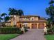Stately Mediterranean home with a spacious paver driveway, attached garages and professionally landscaped front yard at 416 Baycrest Dr, Venice, FL 34285
