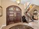 Inviting foyer features tile floors, wood door with decorative glass and staircase at 416 Baycrest Dr, Venice, FL 34285