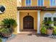 Mediterranean style front door with brick walkway and decorative planters at 416 Baycrest Dr, Venice, FL 34285