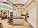 Open kitchen with granite counters, island, tiled floors and stainless steel microwave at 416 Baycrest Dr, Venice, FL 34285