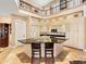 Modern kitchen featuring a central island with seating, stainless steel appliances, and custom cabinetry at 416 Baycrest Dr, Venice, FL 34285