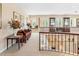 Open upstairs landing area with an overview of downstairs, decorative furnishings, and large, bright windows at 416 Baycrest Dr, Venice, FL 34285