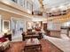 Bright, spacious living room with soaring ceilings, ornate details, and seamless flow to the dining and kitchen areas at 416 Baycrest Dr, Venice, FL 34285