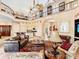 Expansive living room with a balcony, high ceilings, comfortable seating, and an open floor plan to the kitchen at 416 Baycrest Dr, Venice, FL 34285