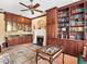 Inviting living room featuring a fireplace, custom cabinets with glass doors, and a unique decorative table at 416 Baycrest Dr, Venice, FL 34285