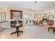 Bright loft with patterned carpeting, a display cabinet, and seating at 416 Baycrest Dr, Venice, FL 34285