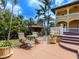 Outdoor seating area with lush landscaping and a staircase leading to the main house at 416 Baycrest Dr, Venice, FL 34285