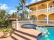 Backyard pool with a built-in spa, tile accents, and a two-story home at 416 Baycrest Dr, Venice, FL 34285