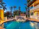 Backyard pool and spa at twilight with tile accents and lush landscaping at 416 Baycrest Dr, Venice, FL 34285