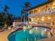 Backyard pool and spa at twilight with tile accents and lush landscaping at 416 Baycrest Dr, Venice, FL 34285